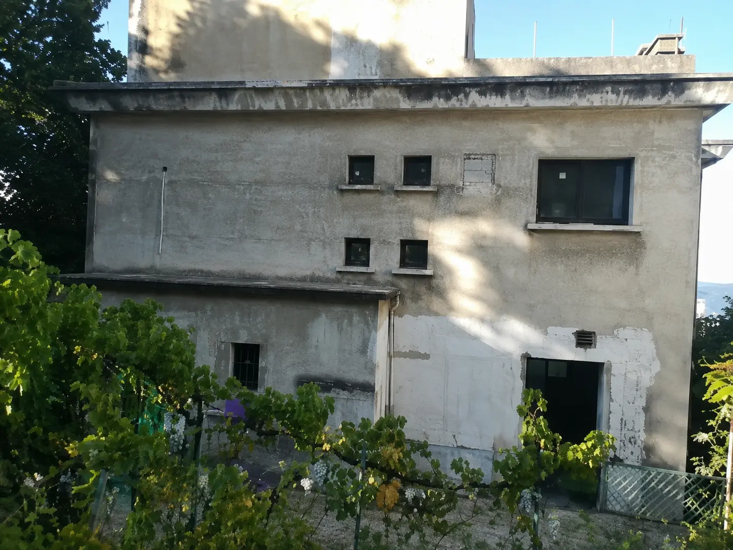 Façade arrière en béton noircie avant ravalement dans la région de Bourgoin-Jallieu